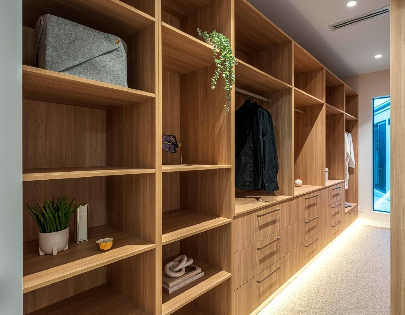 Completed built-in wardrobe cabinetry beside bedroom windows